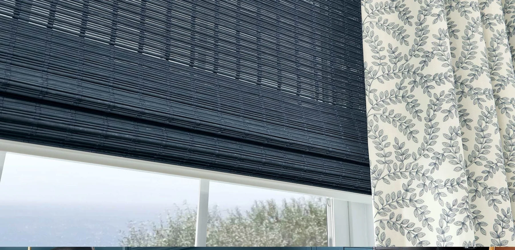 Interior roller shades filtering daylight in a living room