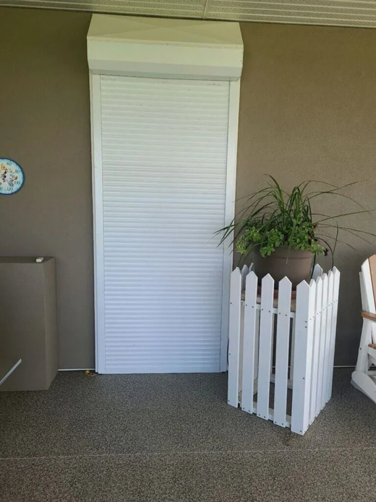 Rolling security shutter partially closed over a doorway