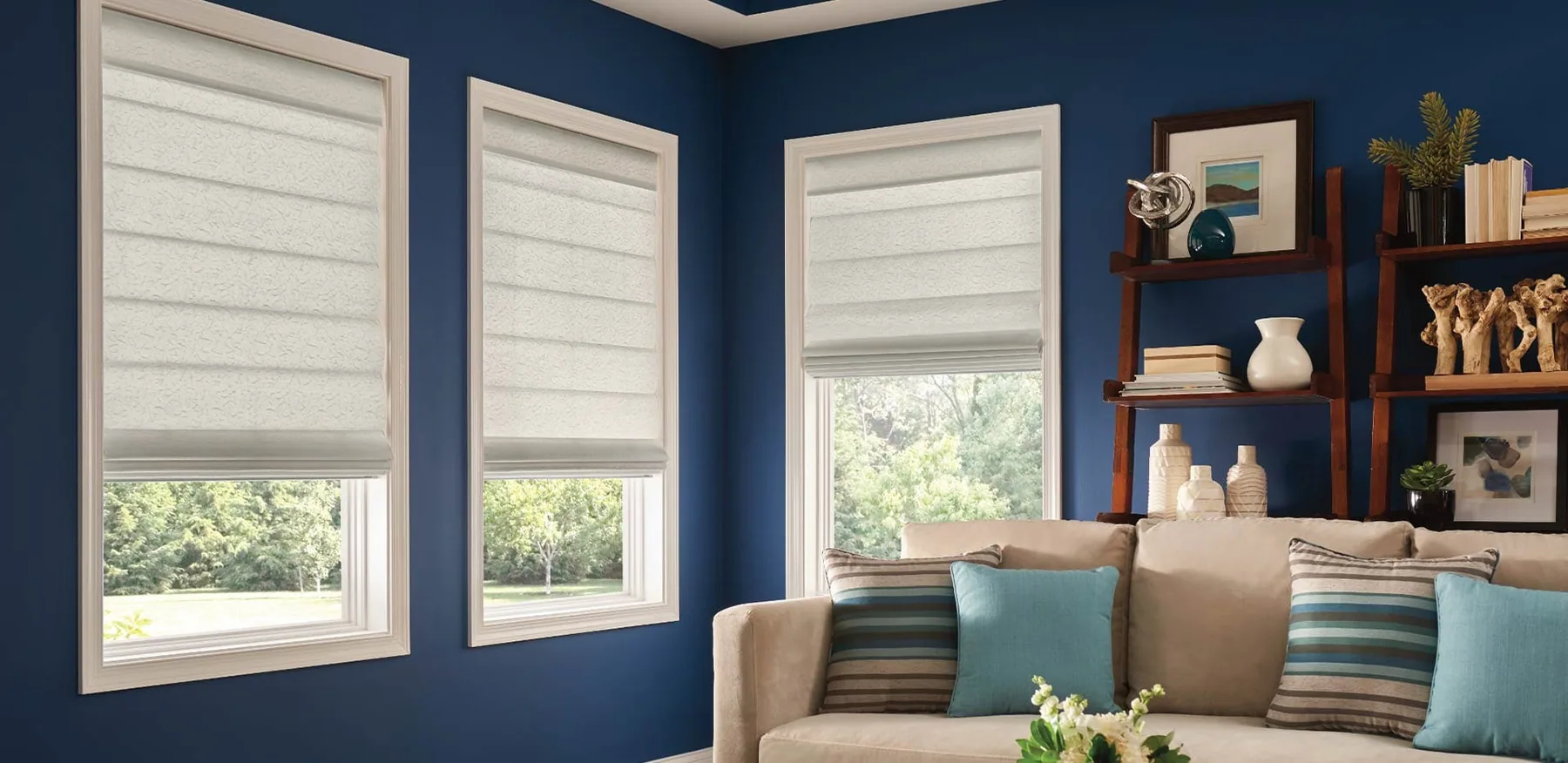 Roman shades styled above a window seat