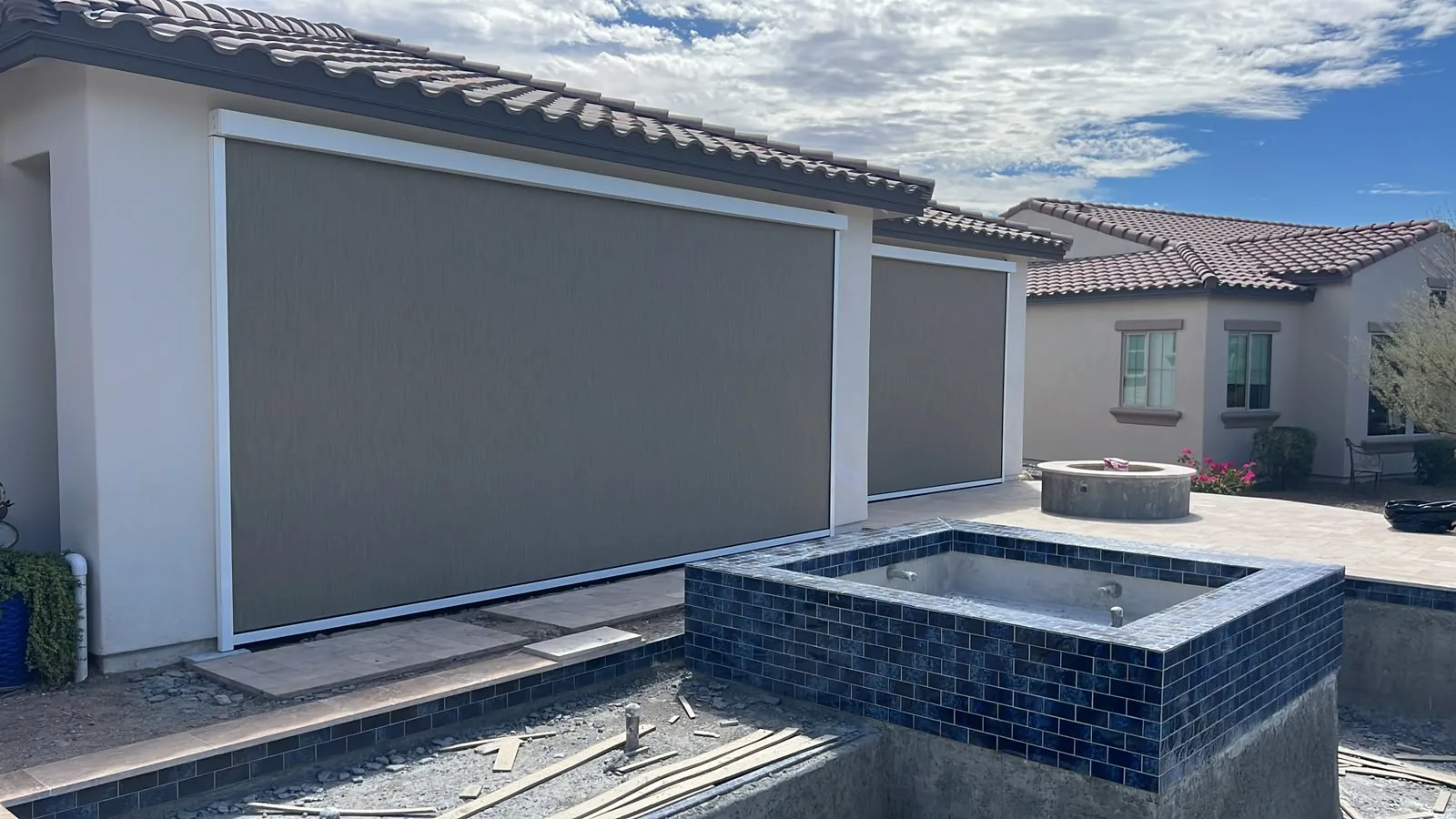 Fabric awning shading a residential patio seating area