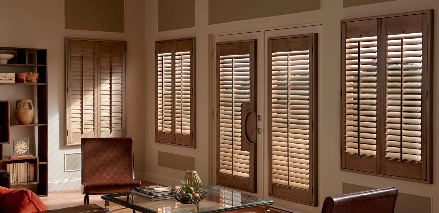 White plantation shutters on a bright interior window