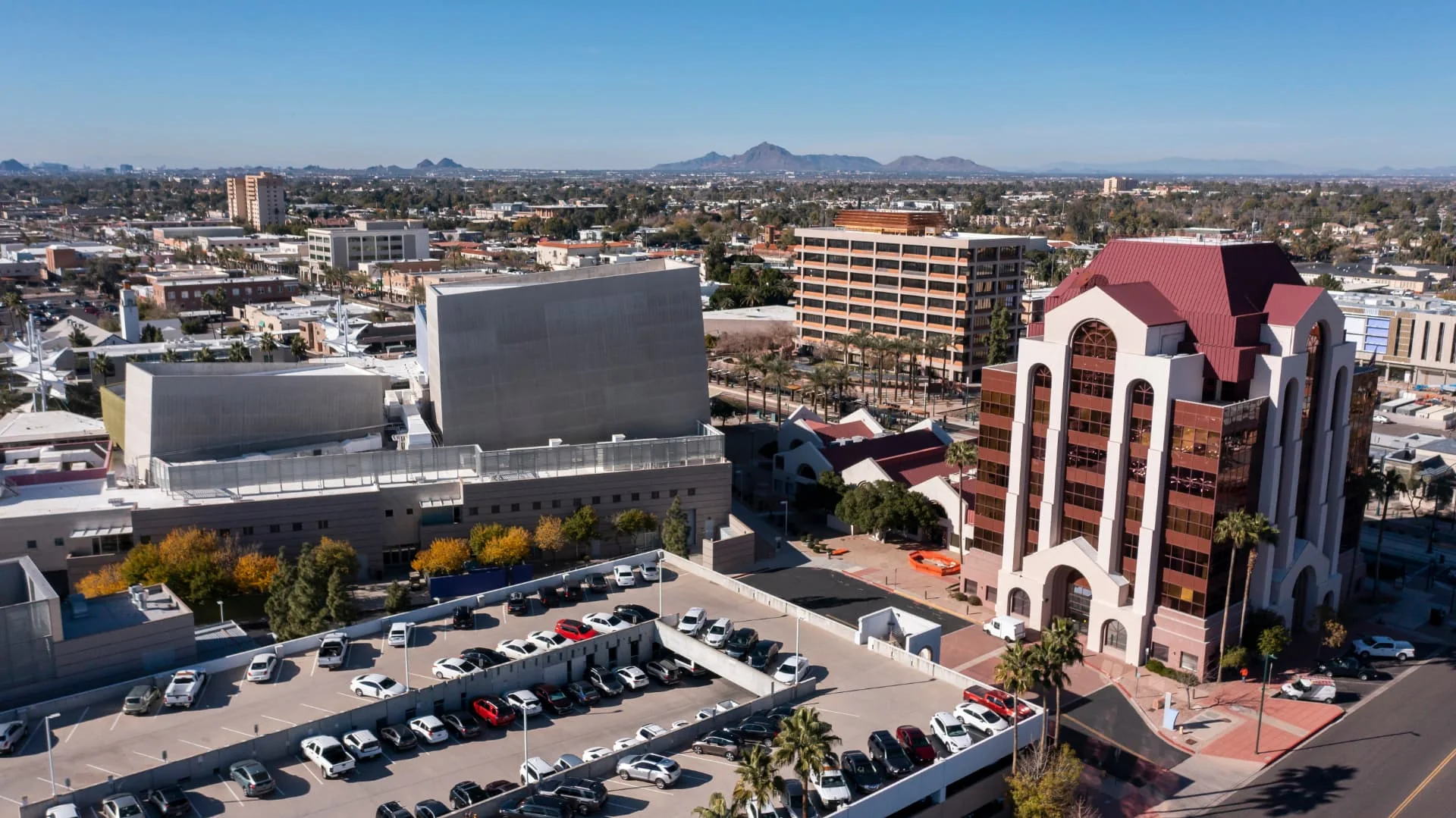 Aerial view of downtown Mesa, Arizona with mountains on the horizon